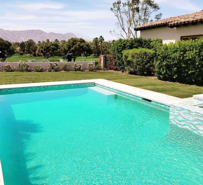 A large swimming pool with mountains in the background