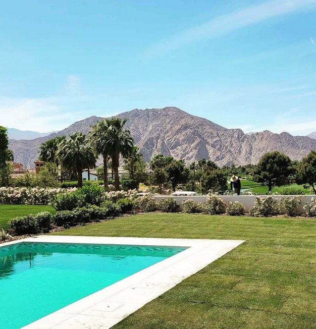 A large swimming pool with mountains in the background