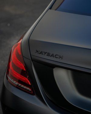 a black maybach car is parked in a parking lot .