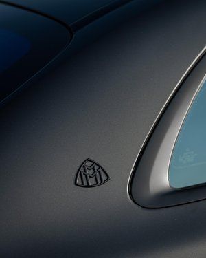 a close up of the side of a car with a mercedes logo on it .