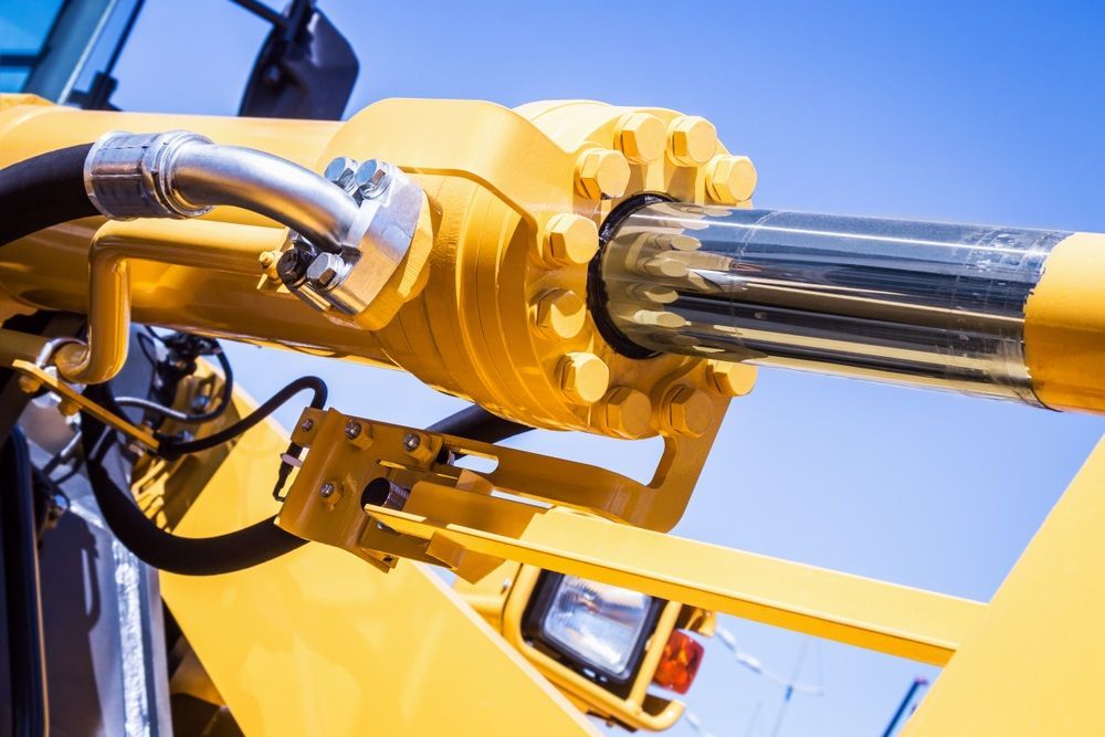 A close up of a yellow hydraulic cylinder on a bulldozer — HI PSI Hydraulics in Kempsey, NSW
