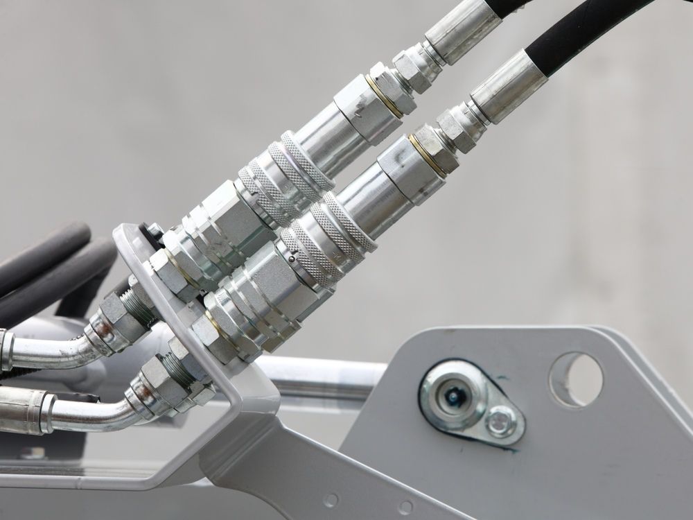 A Close Up Of Two Hydraulic Hoses On A Machine — HI PSI Hydraulics in Laurieton, NSW