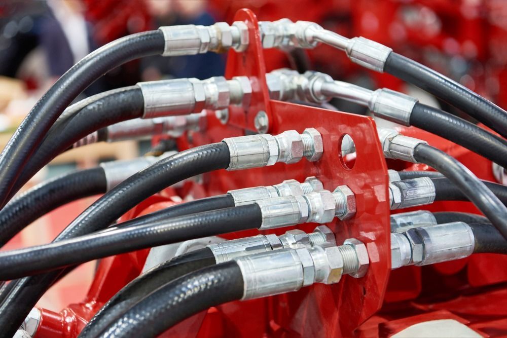 A Bunch Of Hydraulic Hoses Are Connected To A Red Machine — HI PSI Hydraulics in Forster, NSW