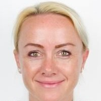 A close up of a woman 's face with a smile on her face.