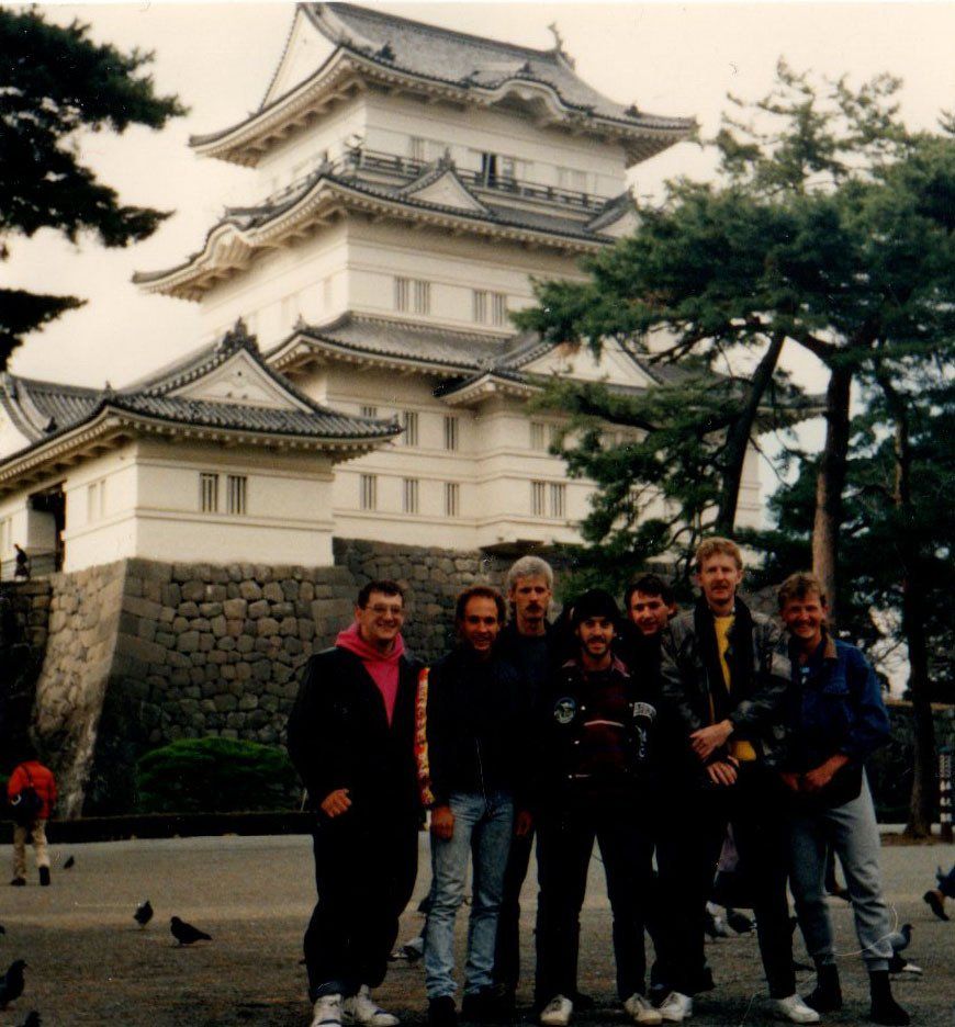 A group of people standing in front of a large building