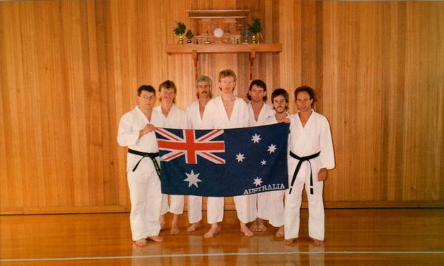 A group of people holding an Australian flag
