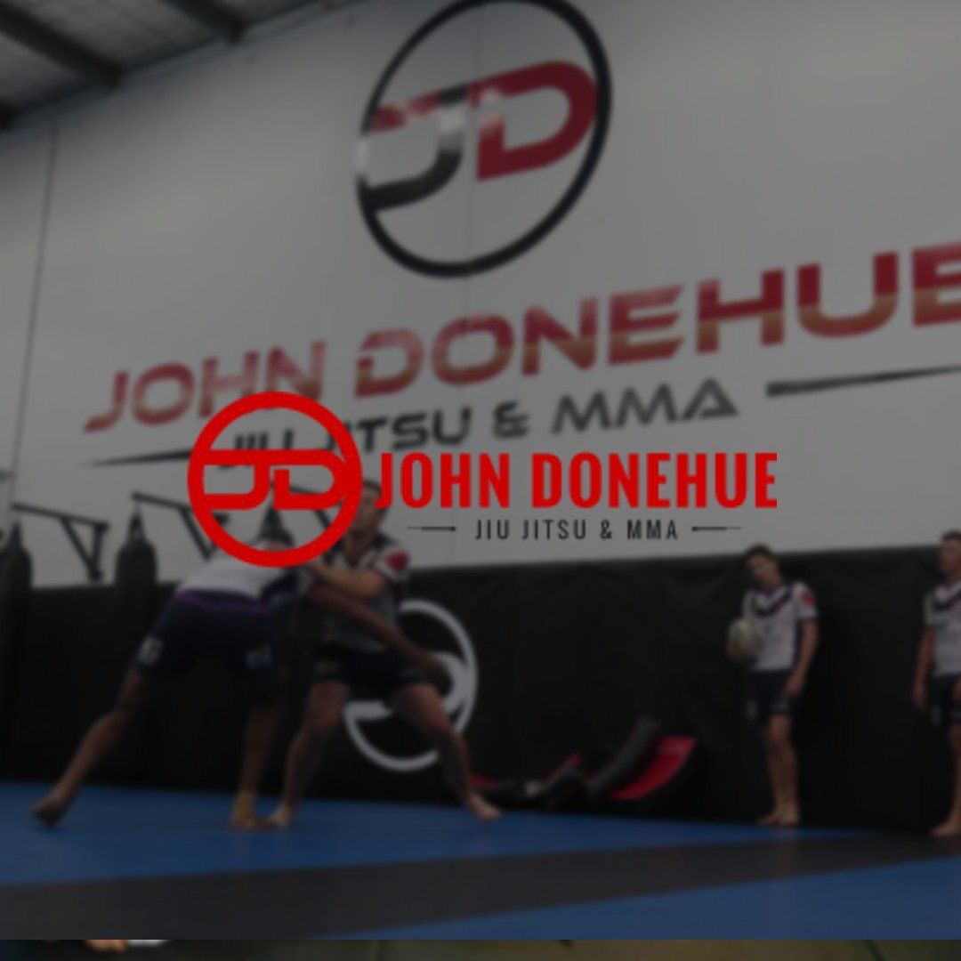A blurred image of a gym with a sign that says john donehue