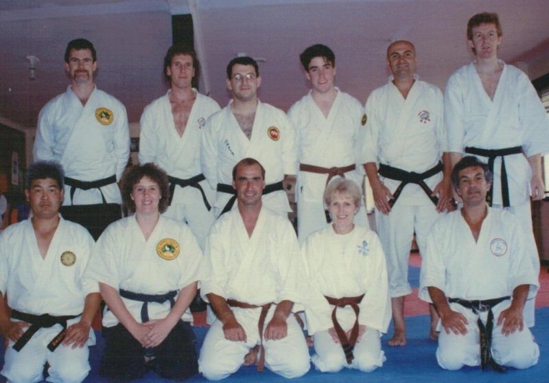 A group of people in karate uniforms pose for a picture