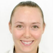 A close up of a woman 's face smiling on a white background.