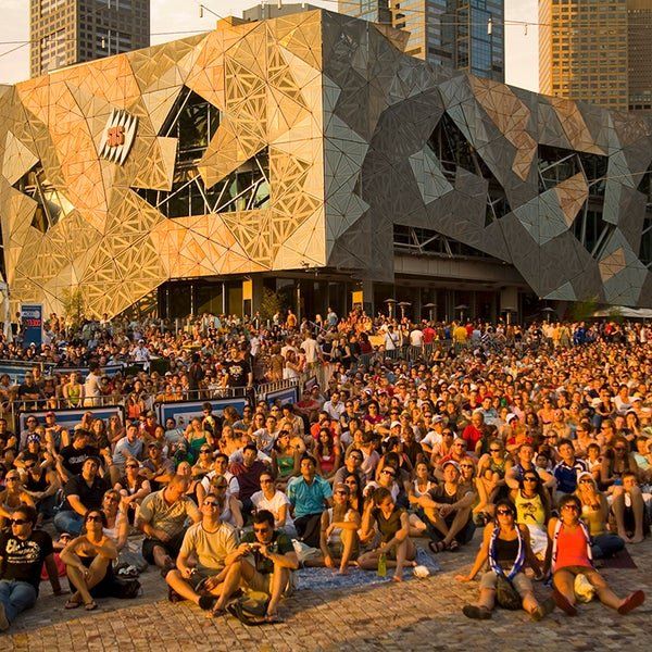 A large crowd of people are gathered in front of a building