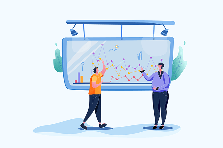 Two people are standing in front of a large whiteboard with graphs on it.