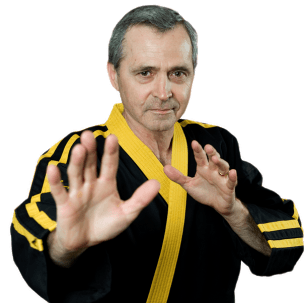 A man in a black and yellow karate uniform is making a stop sign