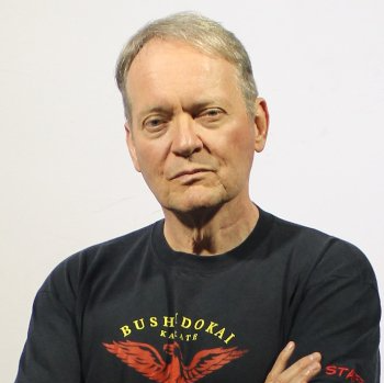 A man wearing a bushidokai t-shirt with his arms crossed