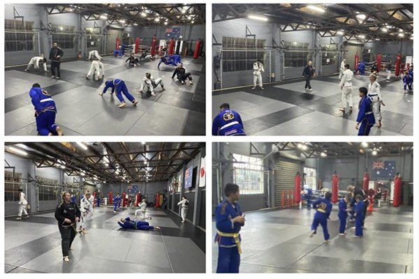 A group of people are practicing martial arts in a gym.