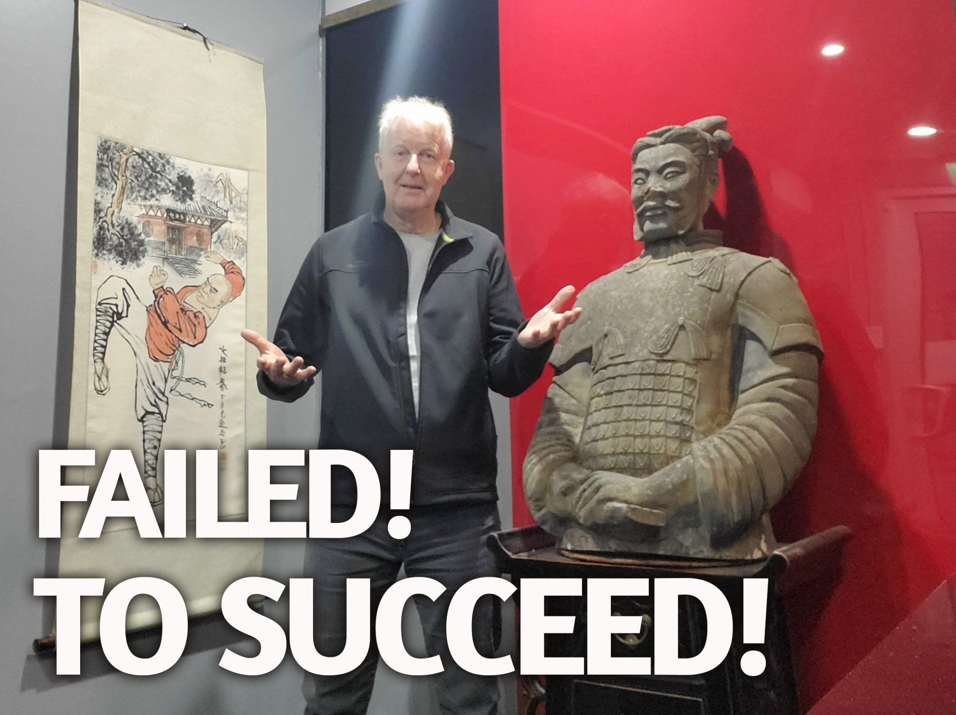 A man standing next to a statue that says failed to succeed