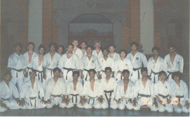 A group of people in karate uniforms pose for a photo