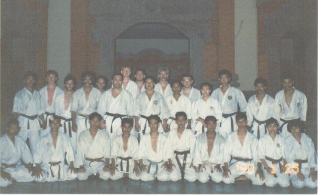 A group of people in karate uniforms pose for a photo