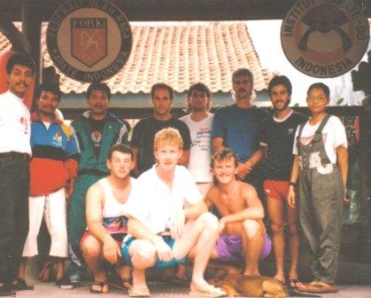 A group of people posing in front of a sign that says indonesia