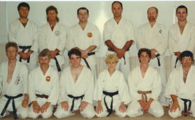 A group of people in karate uniforms posing for a picture