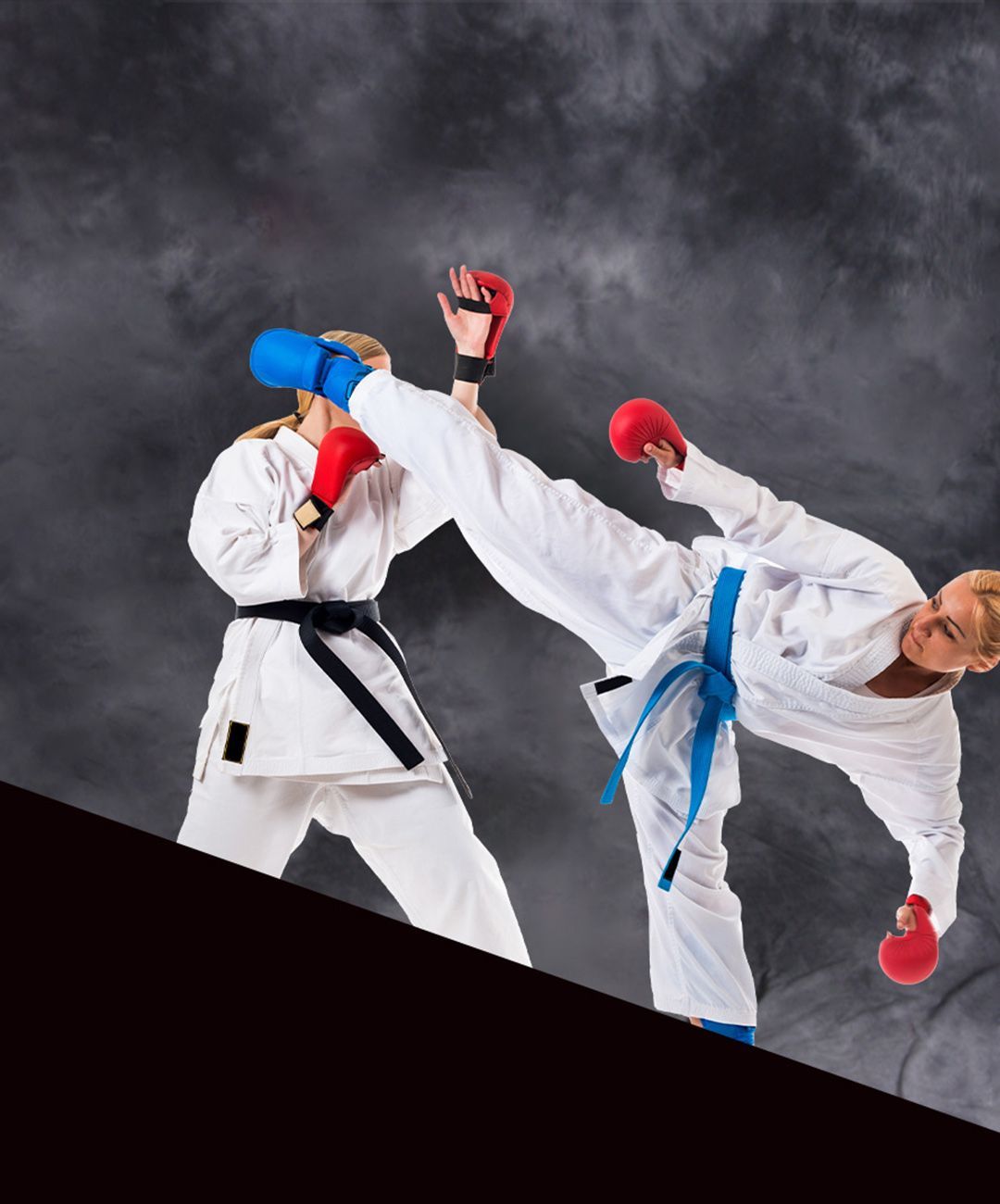 Two karate fighters are kicking each other in the air