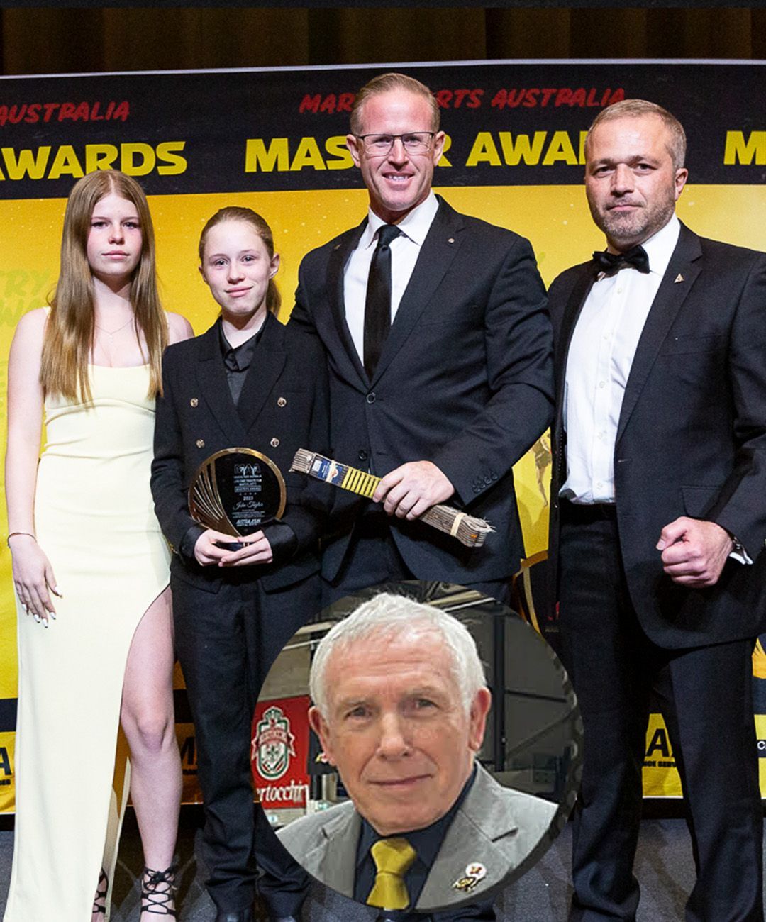 A group of people standing in front of a sign that says awards