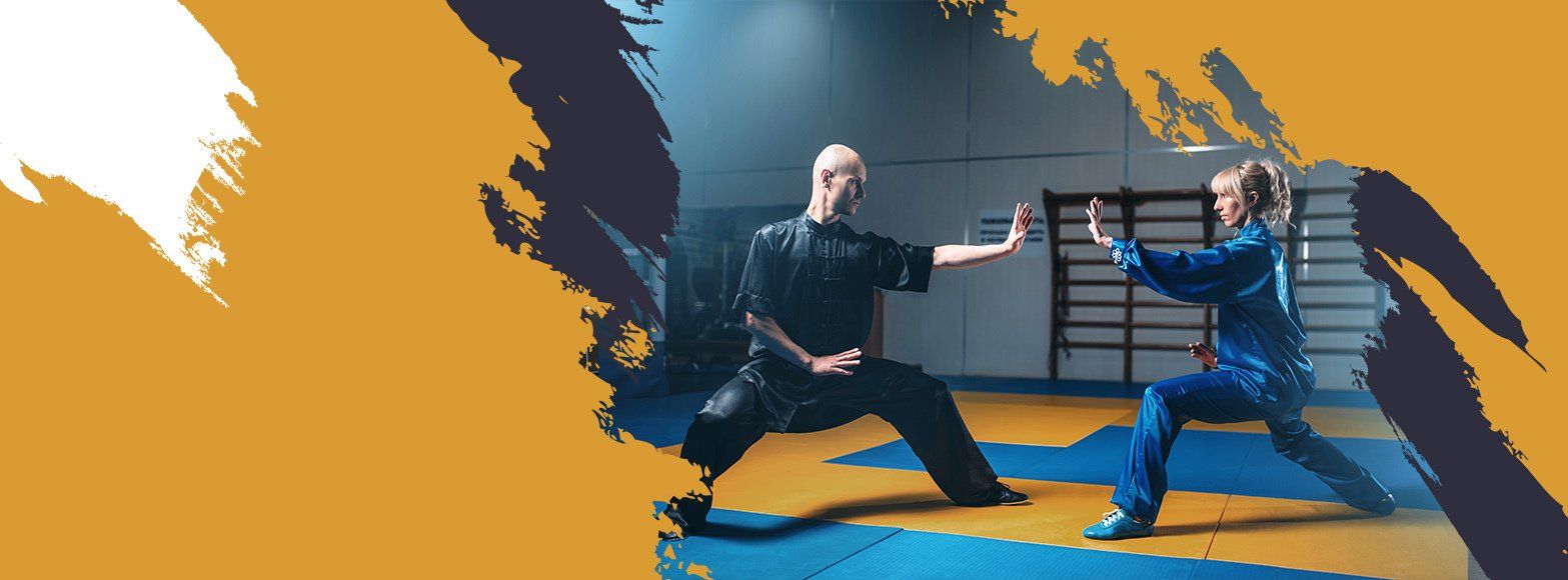 Two men are practicing martial arts in a gym.