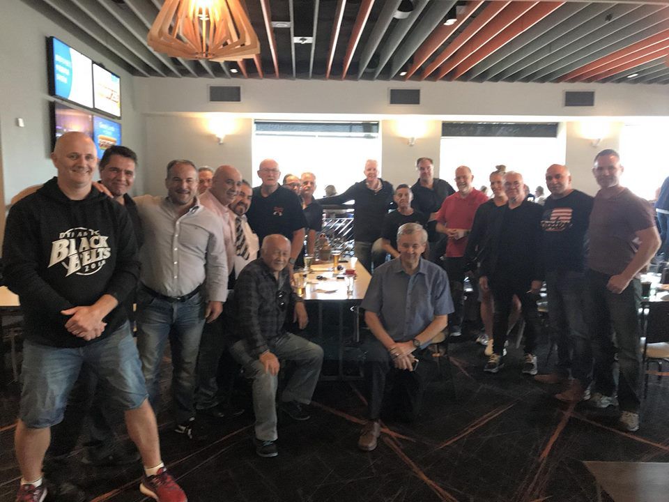 A group of men are posing for a picture in a restaurant.
