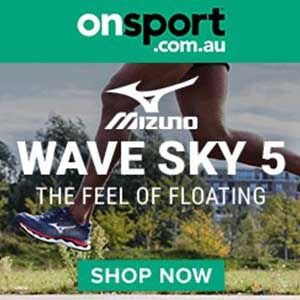 A person is running in a pair of mizuno wave sky 5 running shoes.