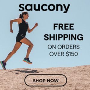A woman is running on top of a sandy hill.