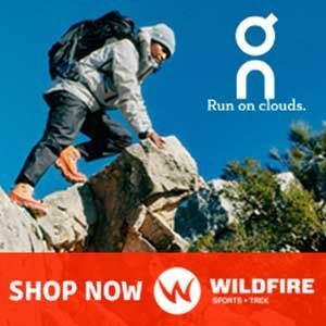 A man with a backpack is climbing a mountain.