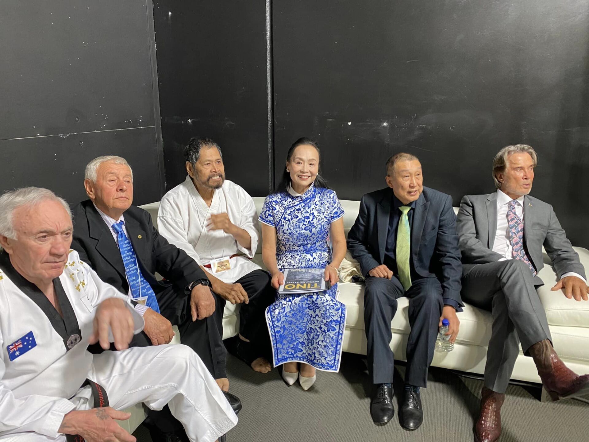 A group of people are sitting on a couch.