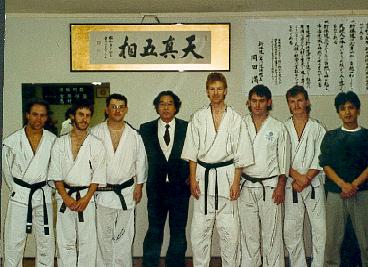 A group of men in karate uniforms pose for a picture
