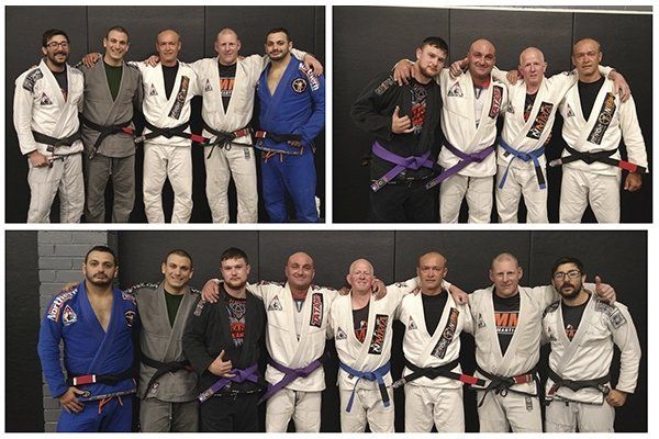 A group of men in karate uniforms are posing for a picture