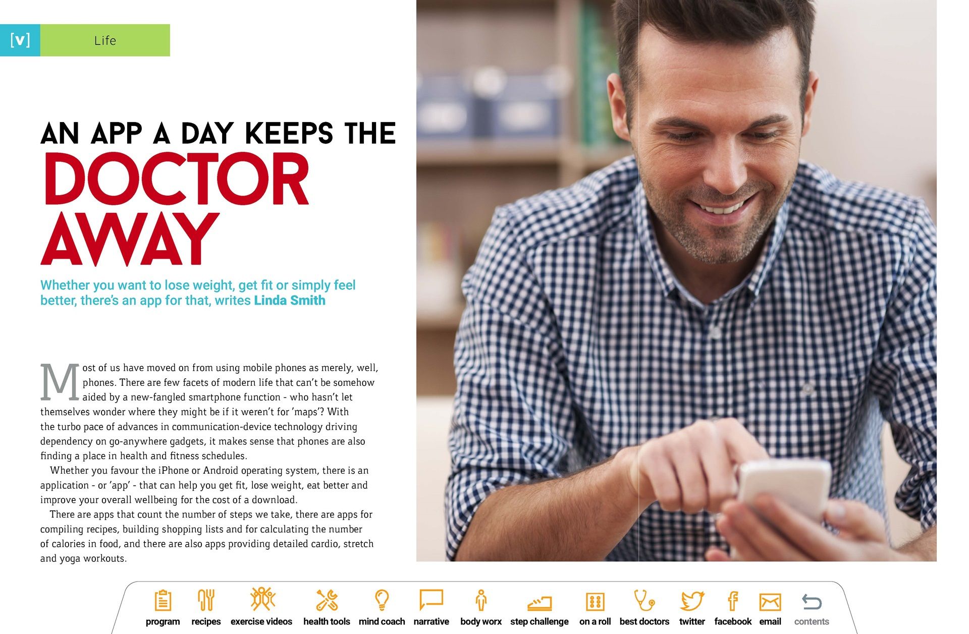A man is smiling while looking at his cell phone.