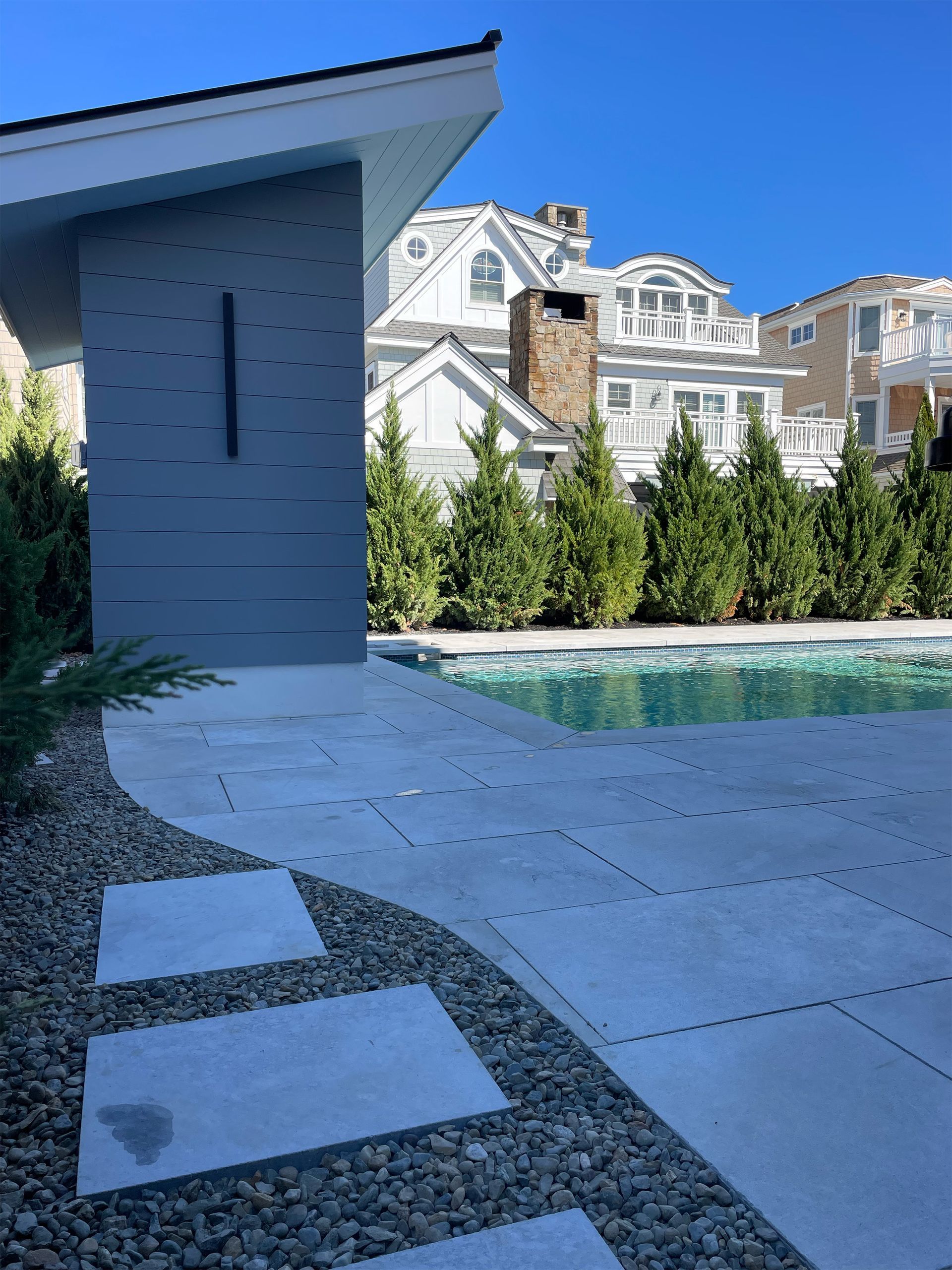 A house with a swimming pool in front of it