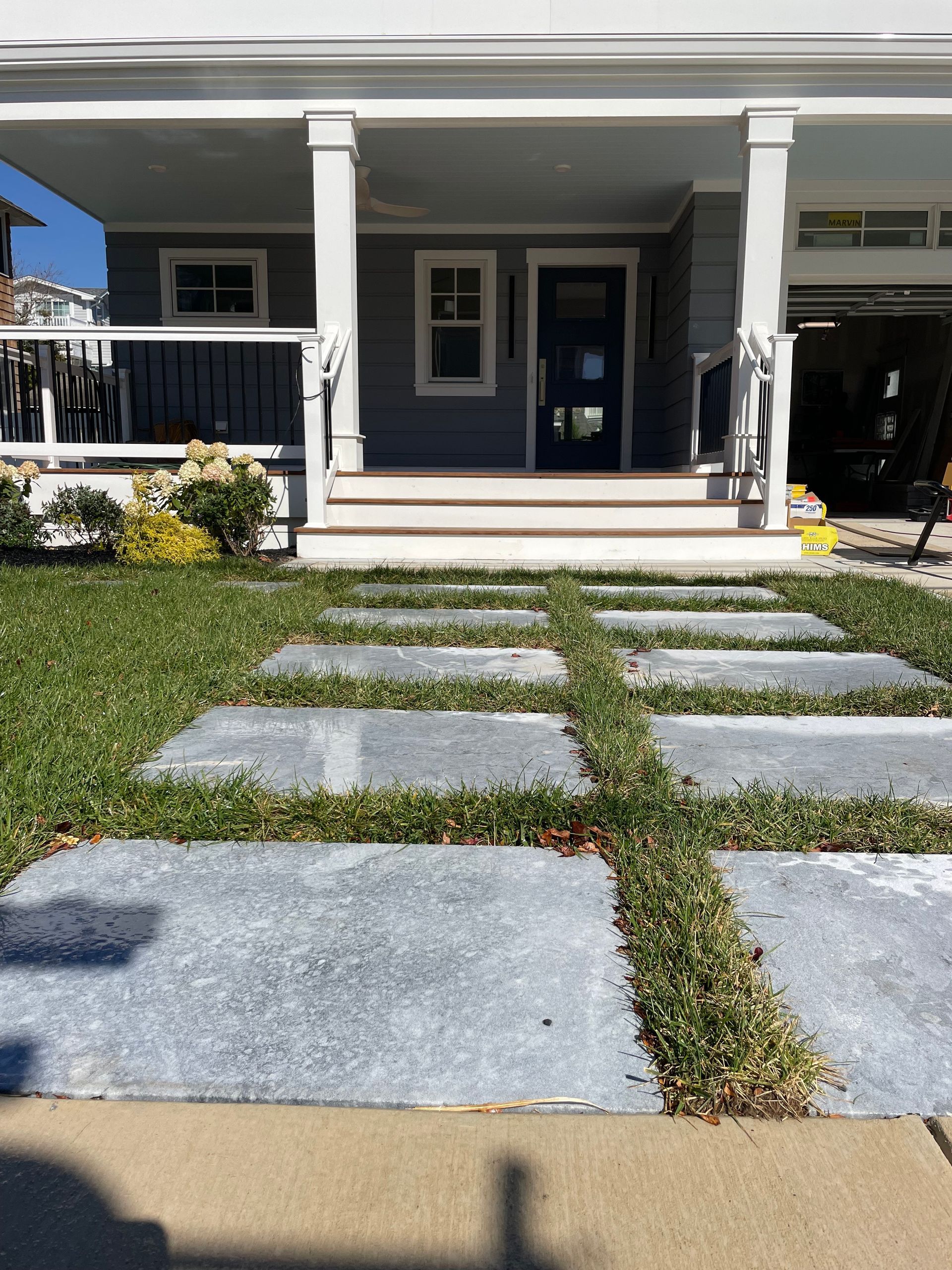 A house with a walkway leading to the front door