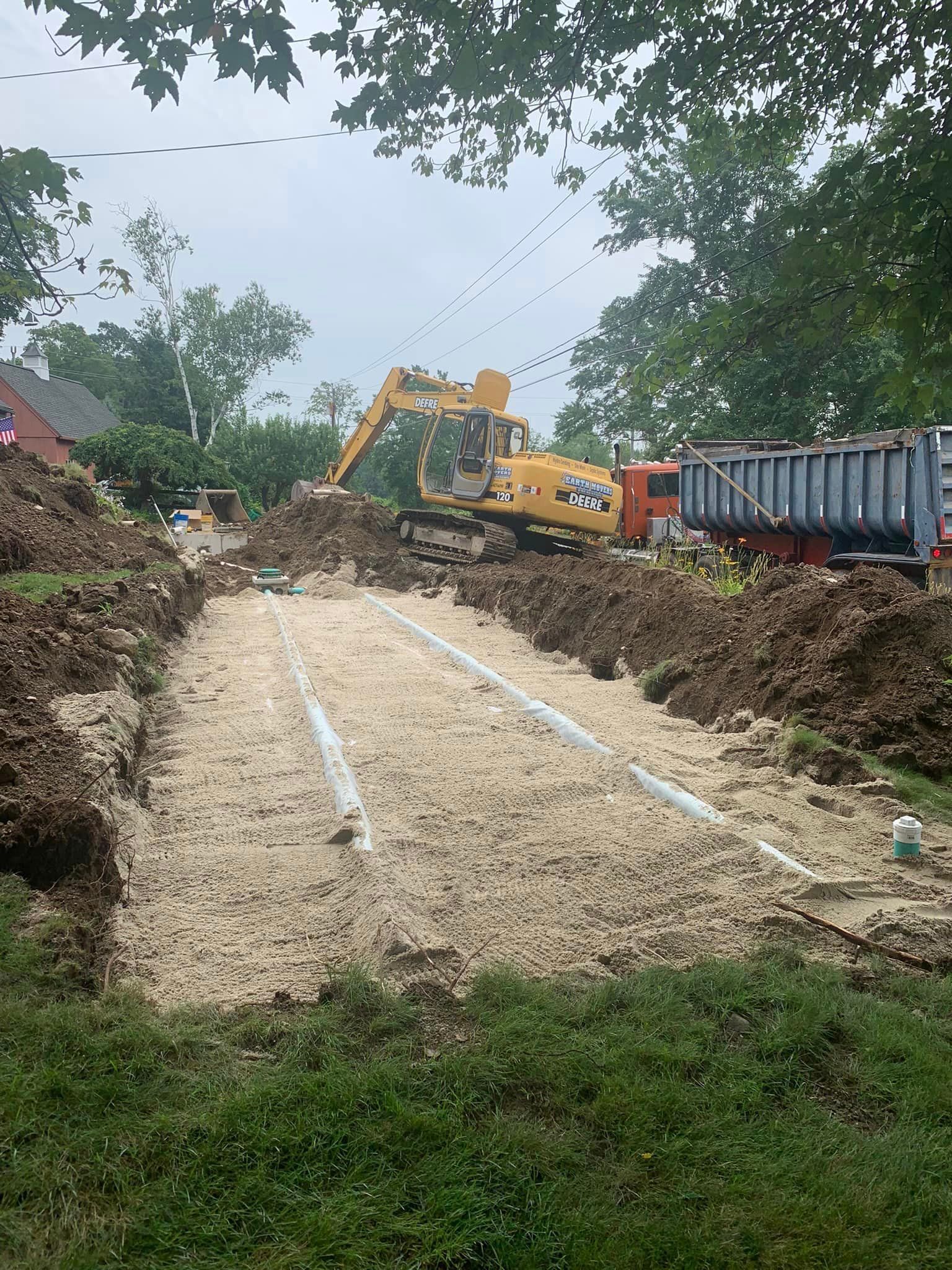 A construction site with a bulldozer and a dump truck.