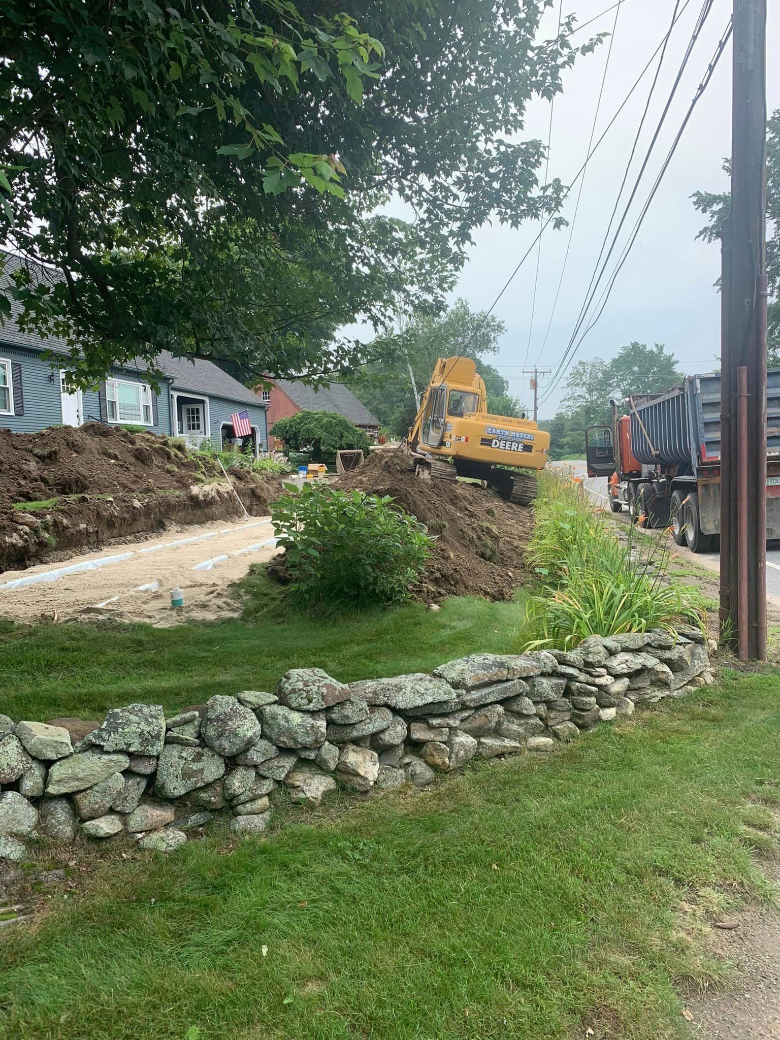 A bulldozer is moving dirt in front of a house.