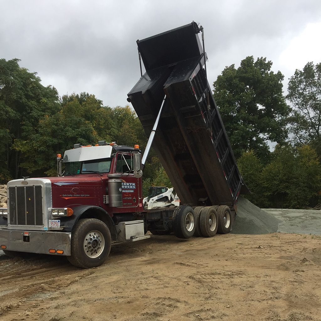 Earth Movers dump truck dumping a load