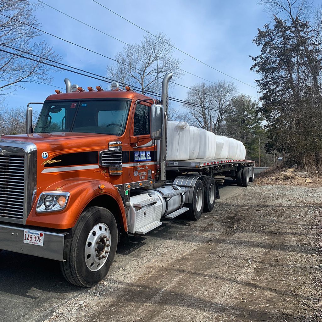 Earth Movers semi truck is parked on the side of the road.