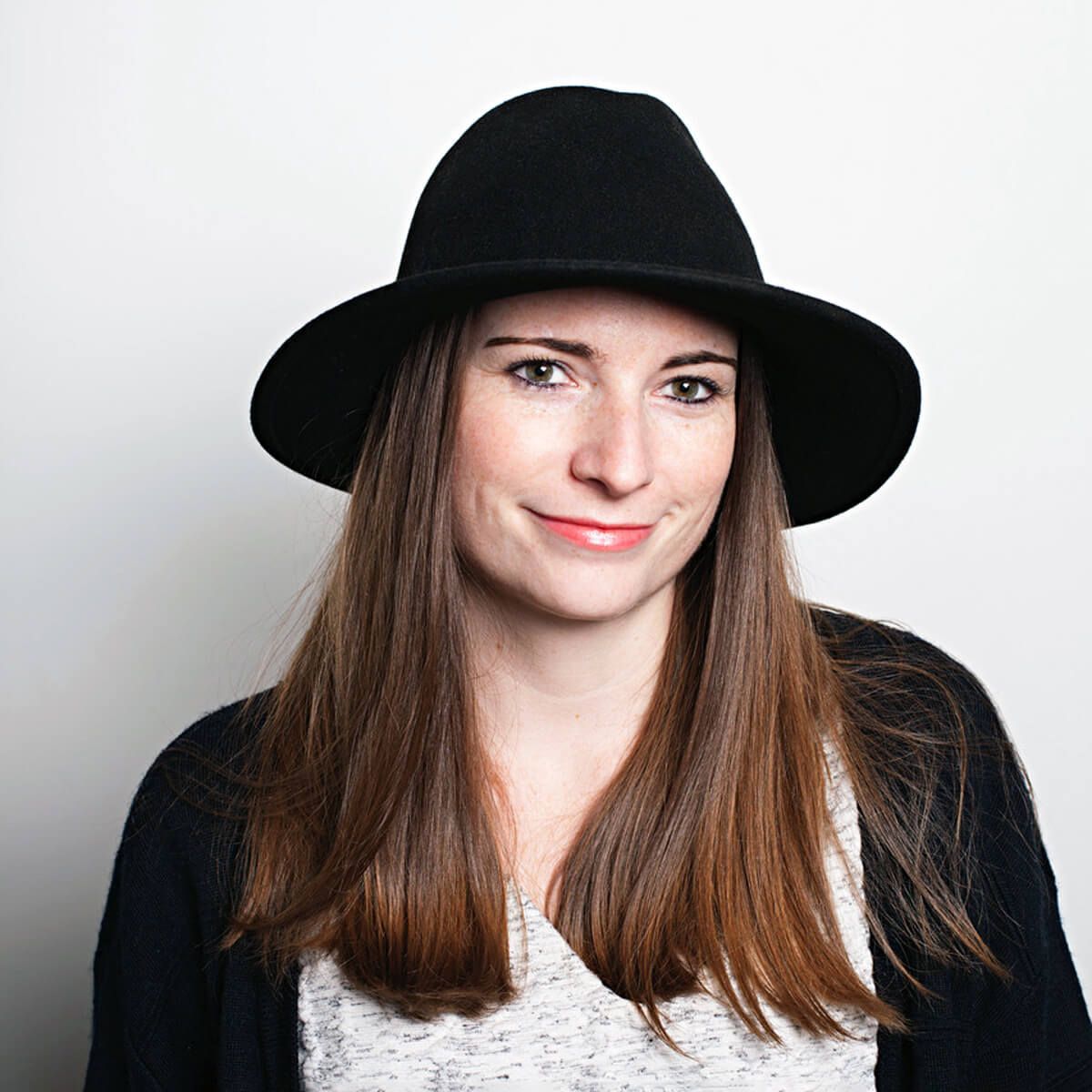 Emma Downing wearing a black hat and cardigan