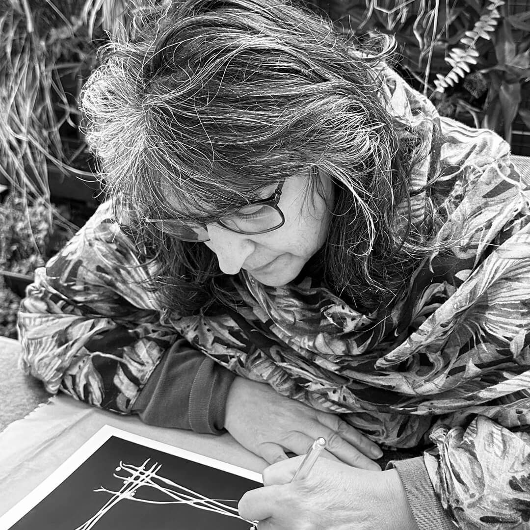 Renee Serraglio has an expression of concentration on her face as she works on a piece of fine-wire jewellery