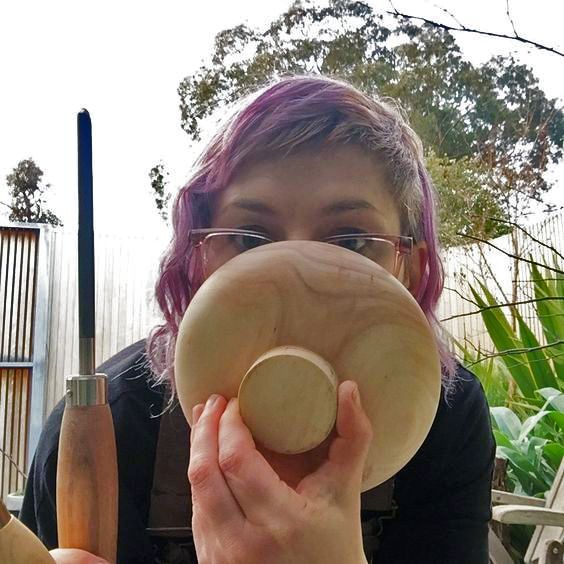 Gillian Martin holds a large, colourfully striped ceramic vessel