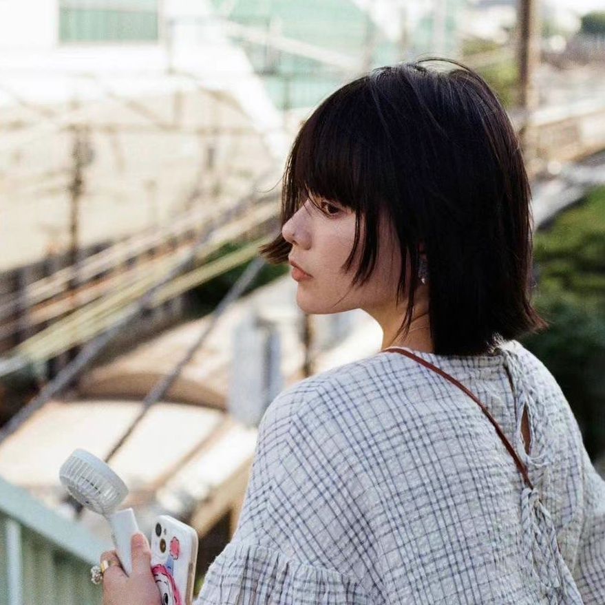 Candice Teok sits at a desk working on an illustration