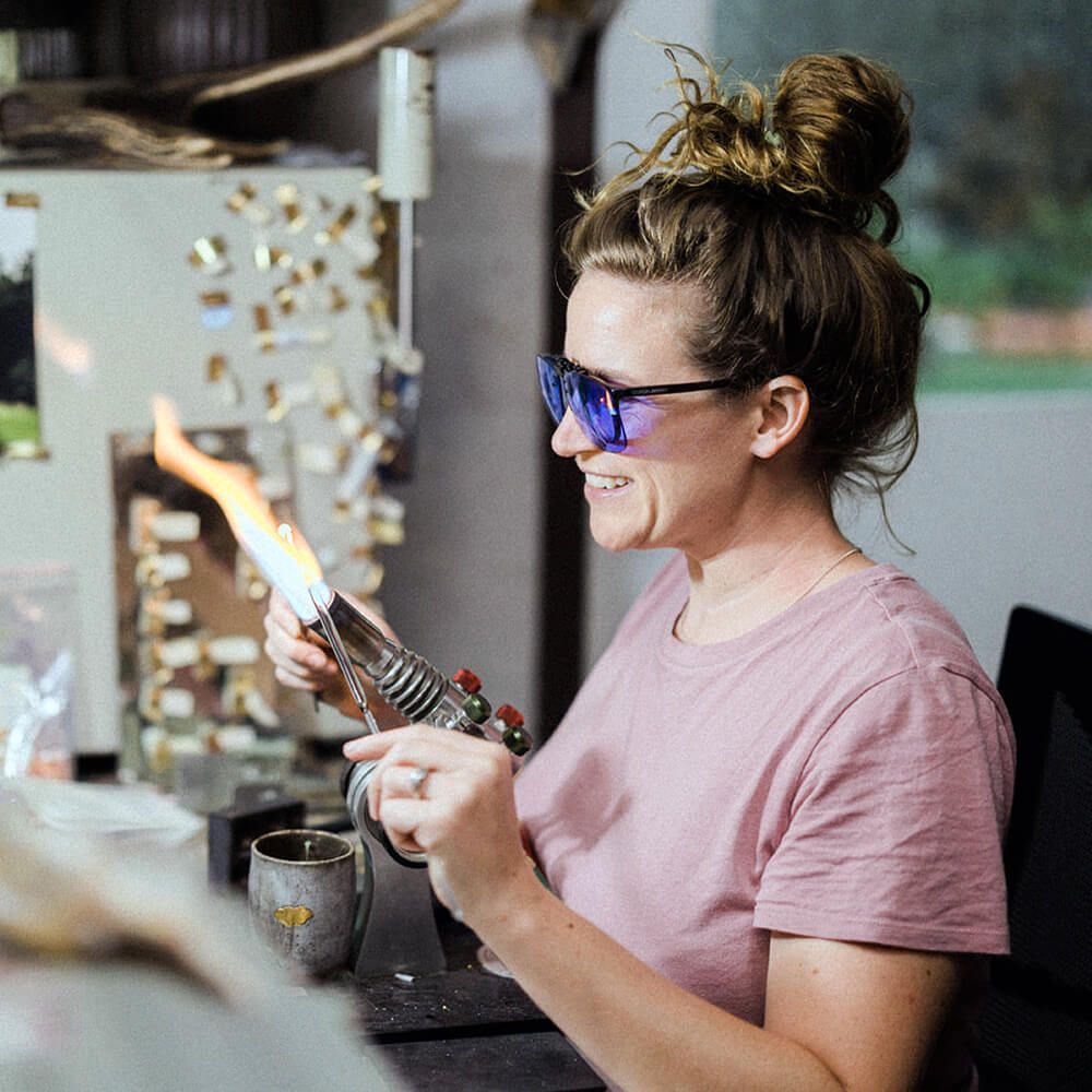 Using the flame from a blowtorch, Sarah Dingwall sculpts a small glass object