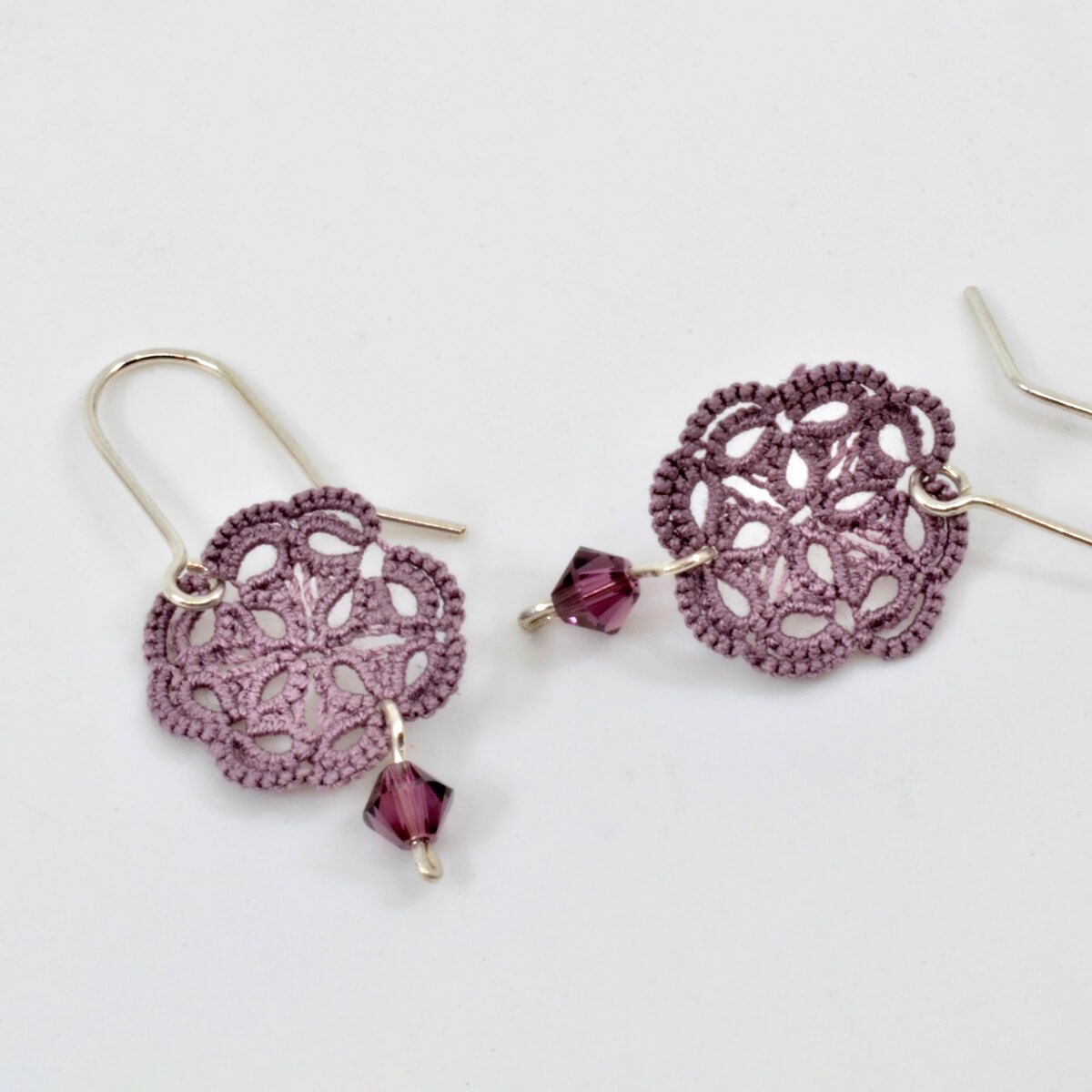 tatted lace earrings in purple thread, with small purple beads