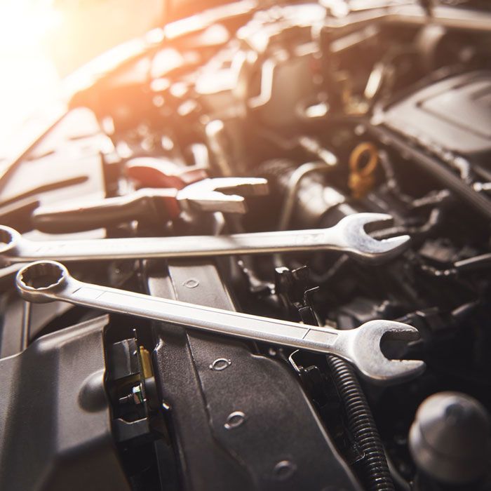 tools sitting on top of car with hood open