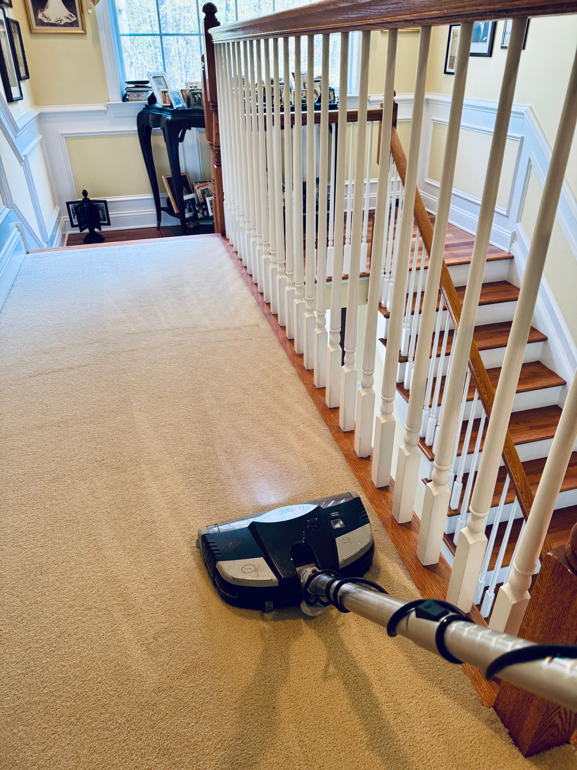 Boxes, ladder, broom, and spray bottle in a room, likely during a move or cleaning.