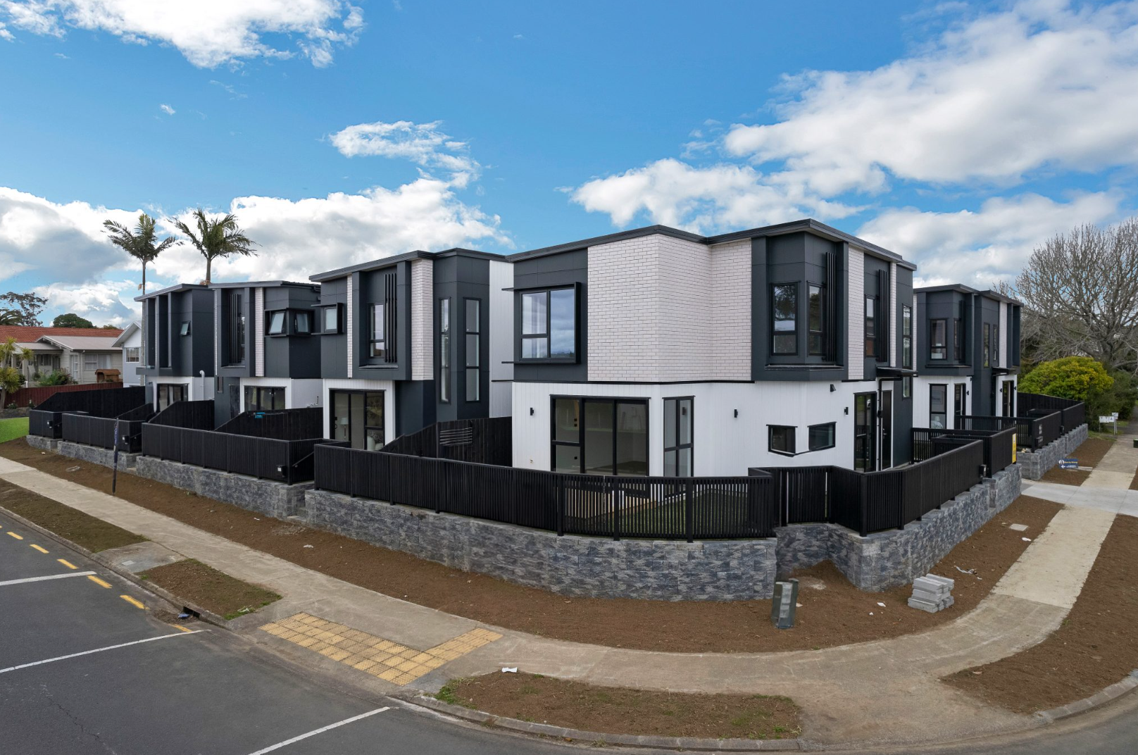 Modern multi-unit development, two-story, in black, white, and gray