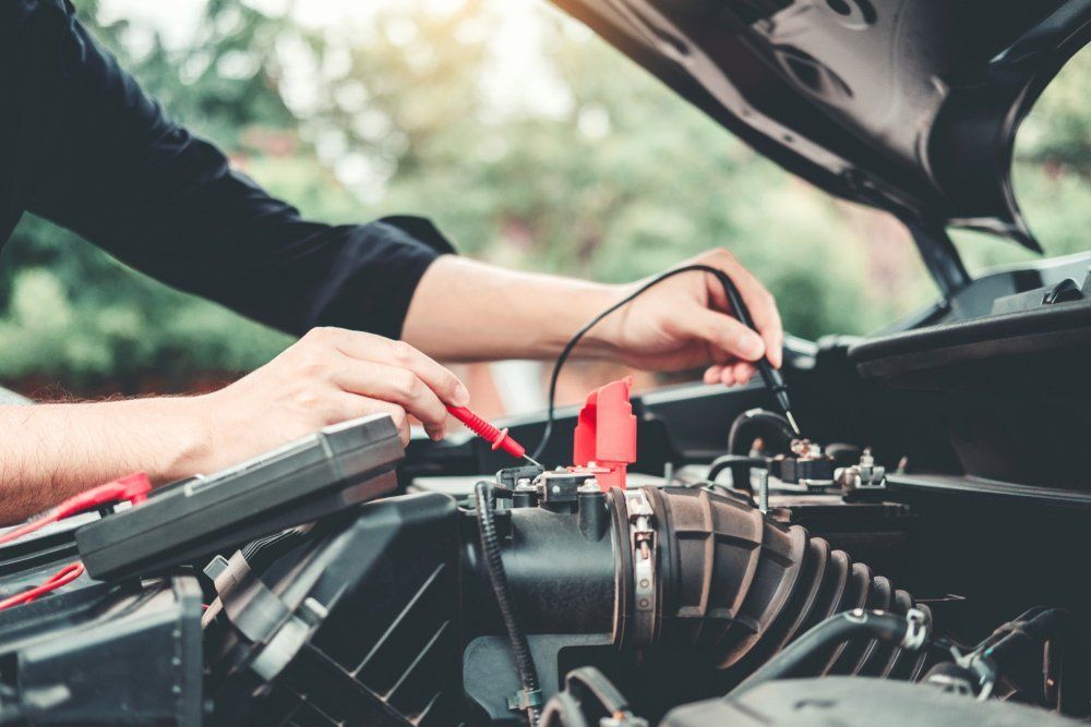 Hands Using a Multimeter to Test a Car Engine — Cool Cars NT in Anula, NT